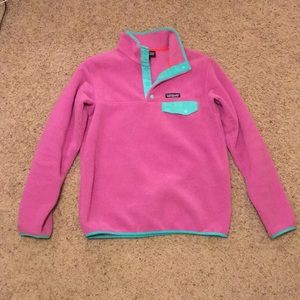 Women’s pink and teal Patagonia fleece.